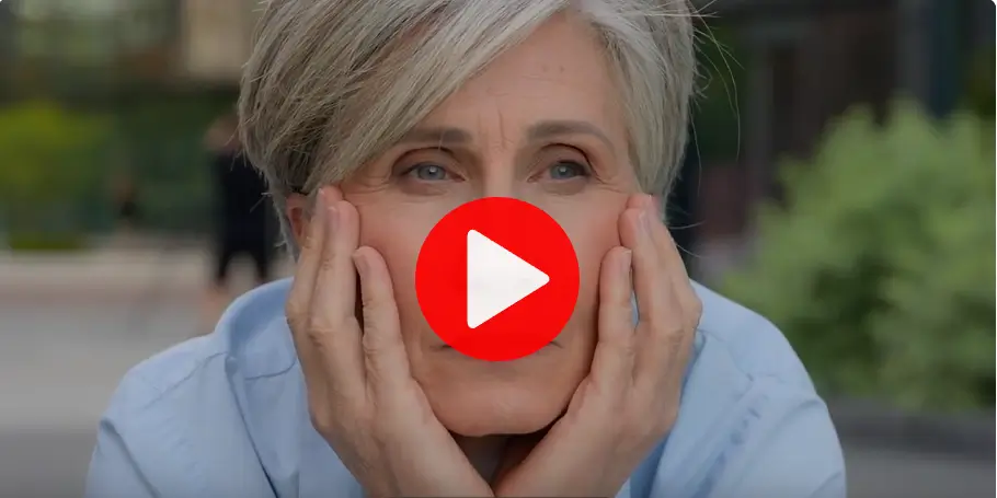 Mature-woman-with-gray-hair-and-a-thoughtful-expression-as-if-struggling-to-remember-something-resting-her-face-in-her-hands-in-an-outdoor-setting